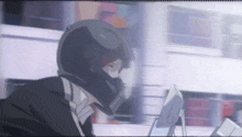 a person wearing a helmet is looking at a screen