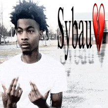 a young man giving the middle finger in front of a sybau heart