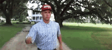 forrest gump is running down a dirt road in a park .