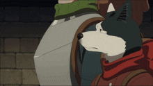 a black and white animal with a red scarf around its neck is standing next to a man