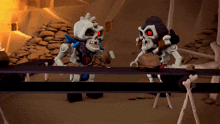 a couple of skeletons standing next to each other on a table