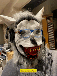 a person wearing a werewolf mask and headphones has a yellow sticker on their sweater that says lupo mann ago