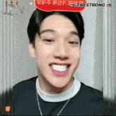 a close up of a man 's face with a red sign that says jin on it