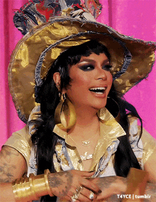 a woman wearing a hat and earrings is smiling and has a t4yce tumblr watermark