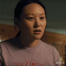 a woman is wearing a purple shirt that says netflix