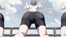 a group of anime girls are dancing on a balcony with a blue sky in the background .