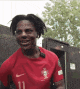 a man is wearing a red nike shirt with the number 11 on it