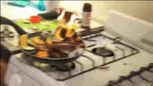 a pan of food is cooking on a white stove