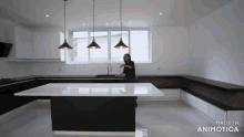 a woman stands in a kitchen with the words made in animotica on the bottom right