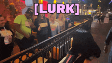 a group of people are standing in front of a fence with the words [ lurk ] written above them