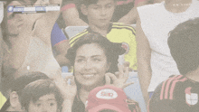a group of people watching a soccer game with the scoreboard showing ecuador 0 to 0