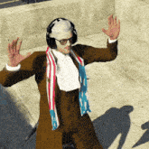a man wearing headphones and a scarf has his hands up