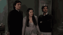 a group of people are standing around a table and chairs