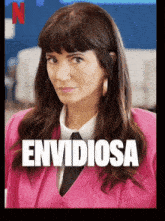 a woman in a pink suit and tie with the word envidiosa on the front