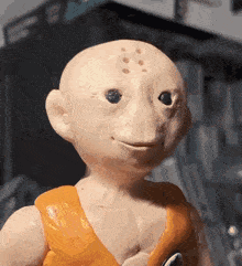 a close up of a statue of a bald man with holes in his face