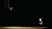 a basketball player throws a basketball in the air