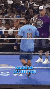 a man in a blue shirt with the number 13 on the back