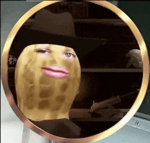 a peanut wearing a cowboy hat and pink lips is in a mirror