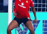 a soccer player wearing a red shirt that says snapdragon