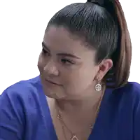a woman with a ponytail wearing a blue sweater and gold earrings