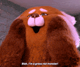 a stuffed animal with its mouth open says " blah i 'm a gross red monster "