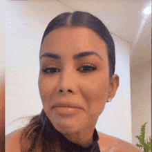 a woman with a ponytail looks at the camera