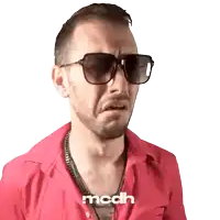 a man wearing sunglasses and a red shirt has the word modh on the bottom right