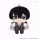 a stuffed toy of a black haired boy with a red tie