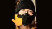 a person wearing a white mask and a yellow hand pointing