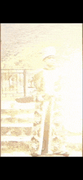 a man standing in front of a fence with the word sah in the background