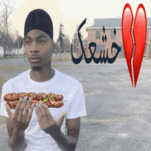 a man in a white shirt is holding a skewer of food in his hands
