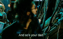 a man in a suit says " and so 's your dad " in front of a joker