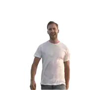 a man wearing a white t-shirt and jeans stands with his arm outstretched