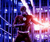 a man in a flash suit is holding a lightning bolt
