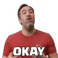 a man in a red shirt says okay with his hands in the air