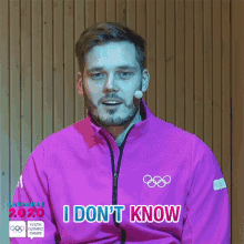 a man wearing a pink jacket that says i don t know