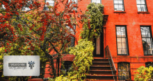 a red brick building with stairs leading up to the front