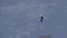 a snowboarder wearing a white helmet and goggles is riding down a snowy slope