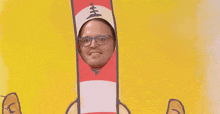 a man wearing glasses and a cat in the hat costume is standing in front of a yellow background .