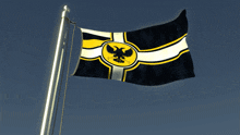 a black white and yellow flag with an eagle in the center
