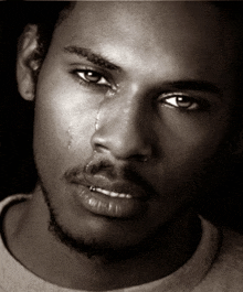 a man with a tear running down his cheek