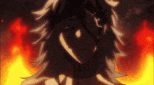 a close up of a person 's face with a fire background