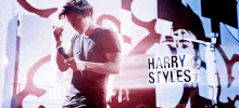 a man singing into a microphone with the words harry styles written on the bottom