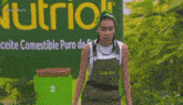 a woman covering her face in front of a sign that says nutri