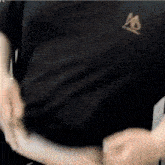 a close up of a person wearing a black t-shirt with a skull on it .