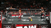 wrestlers in a wrestling ring with the word raw on the bottom