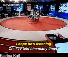 a group of people are sitting in a circle on a stage with the words i hope he 's listening .