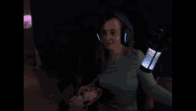 a blurry picture of a person in a blue shirt in a dark room