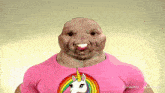 a man wearing a pink shirt with a rainbow unicorn on it