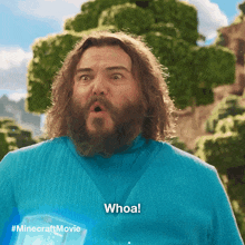 a man with a surprised look on his face is wearing a blue shirt that says whoa